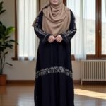 This borkha has a sleek flat one-cut design with detailed embroidery. It is finished with stylish buttons on the sleeves, giving it a unique and elegant touch.