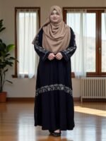 This borkha has a sleek flat one-cut design with detailed embroidery. It is finished with stylish buttons on the sleeves, giving it a unique and elegant touch.