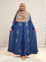 An elegant transparsent georgette pocket cape detailed with frills and intricate work was donned over a shirt.