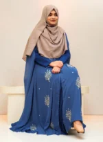 An elegant transparsent georgette pocket cape detailed with frills and intricate work was donned over a shirt.