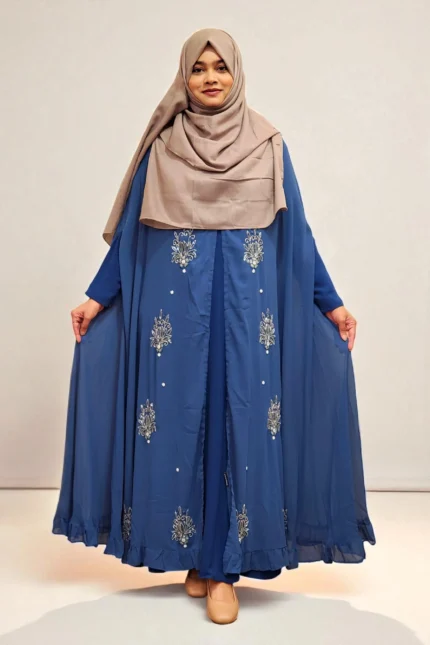 An elegant transparsent georgette pocket cape detailed with frills and intricate work was donned over a shirt.